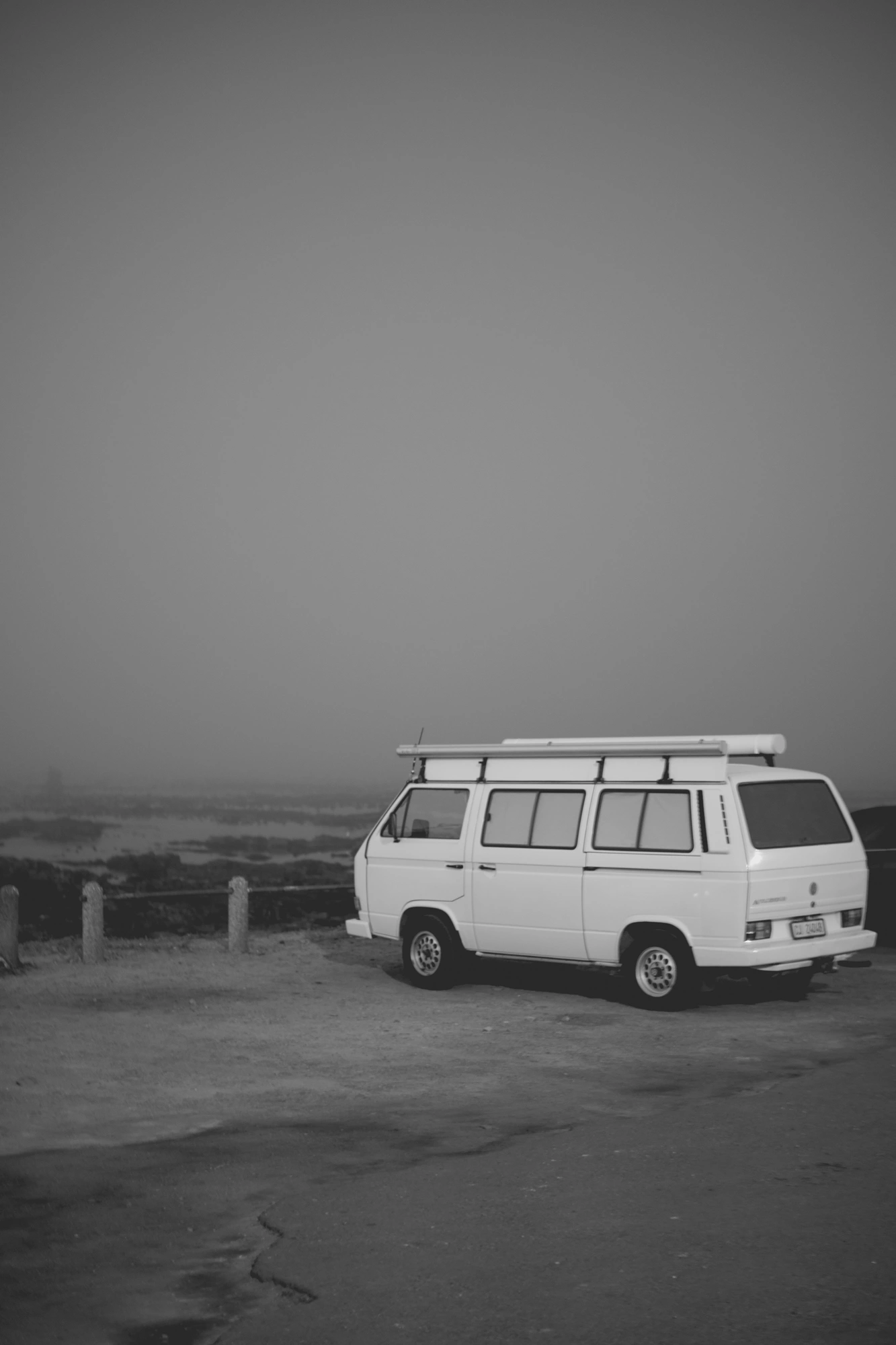 2022-02-15 - xt35 - bw - ZA - Cape Town - Van parked beside beach on misty day