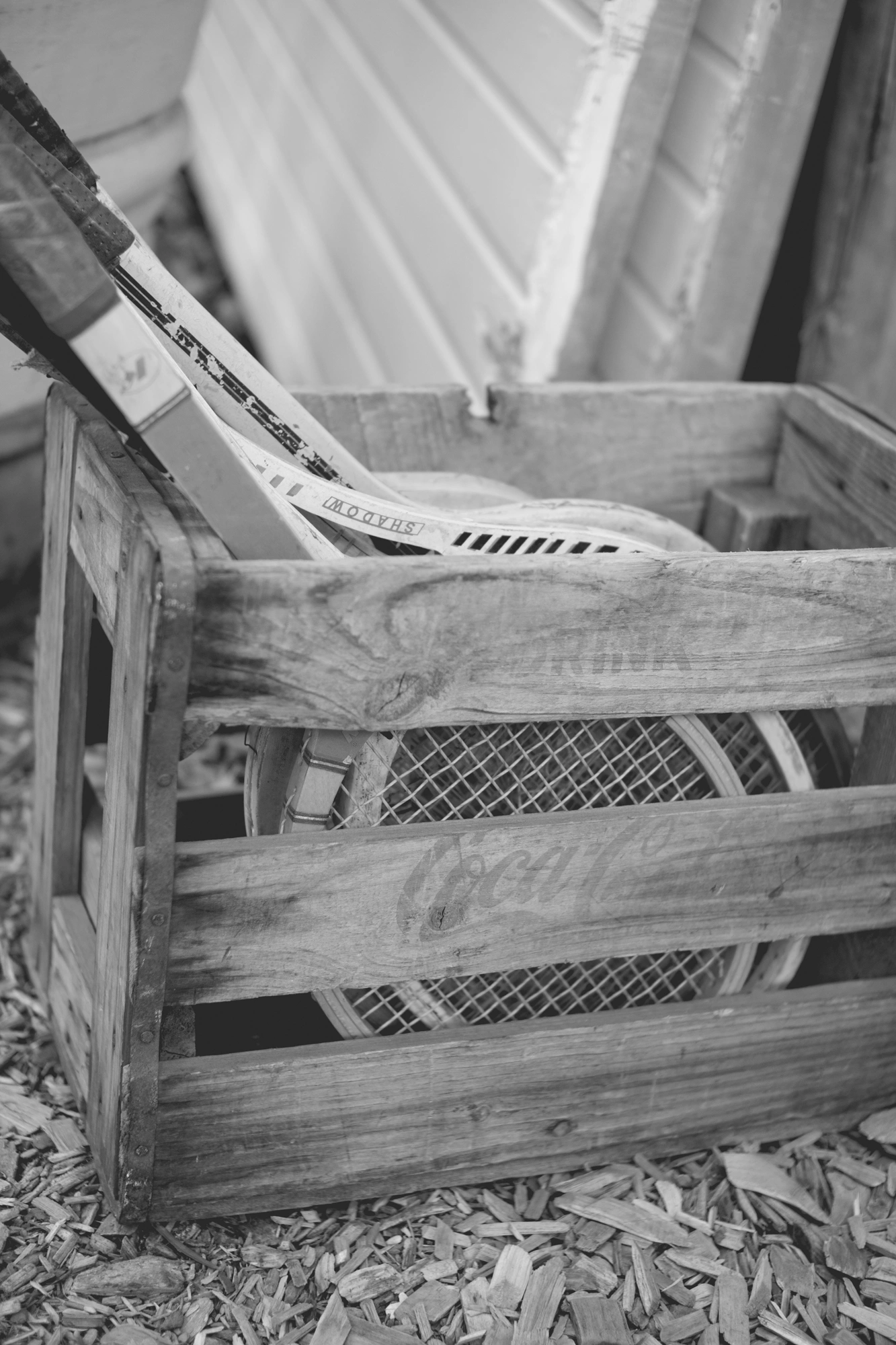 2022-02-18 - xt35 - bw - ZA - Cape Town - Tennis raquets in wooden basket