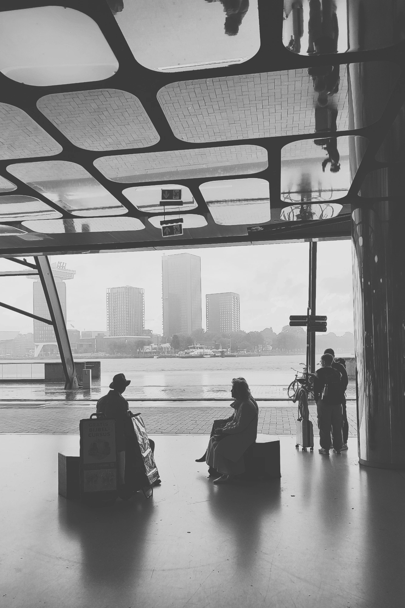 2023-08-01 - redmi - bw - NL - People sitting in train station