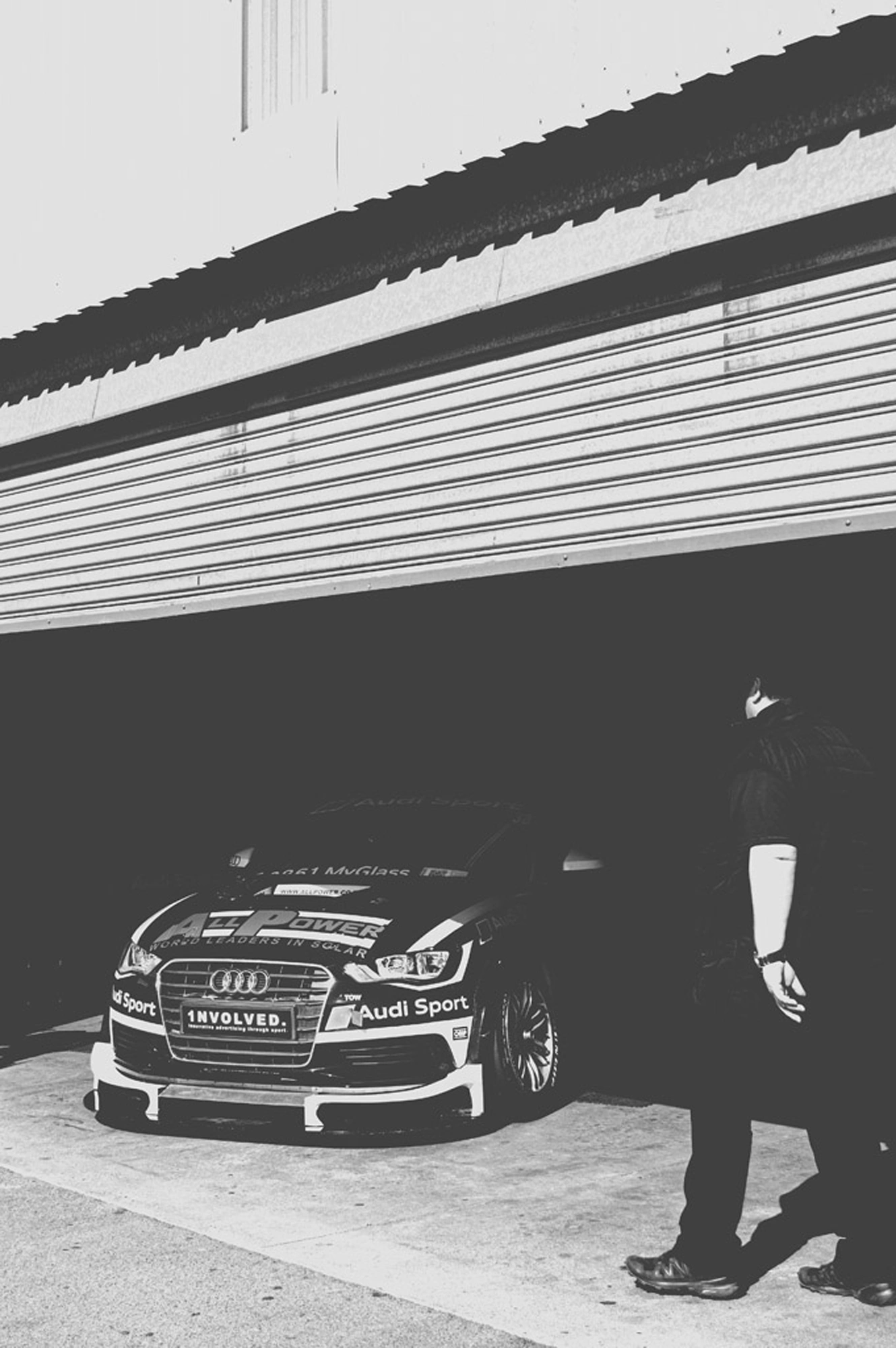 2019-07-27 - n18-55 - bw - ZA - Zwartkops Raceway - Man in shadows crossing a racecar